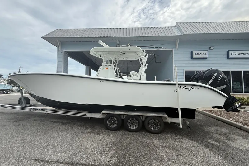 The Image of 2007 Yellowfin 34 Offshore boat on trailer, parked outside a marine dealership. - 0