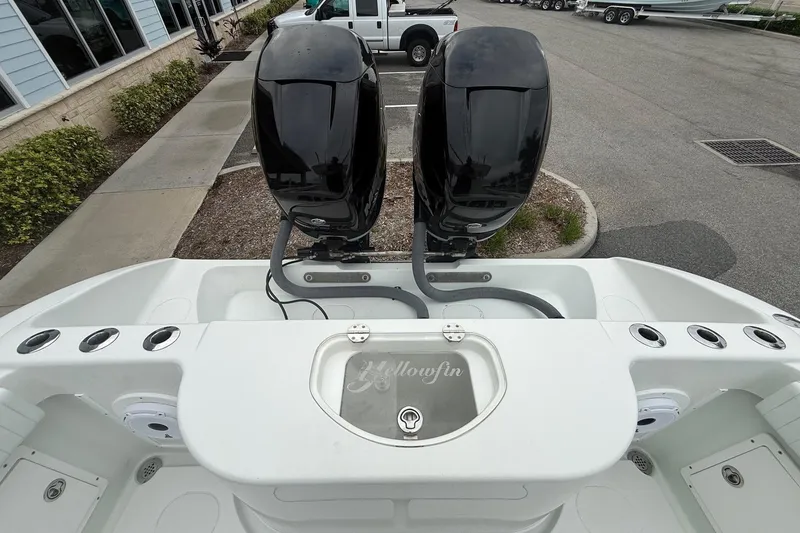 Slide: The Image of 2007 Yellowfin 34 Offshore boat with dual outboard motors, docked near a parking lot. - 14