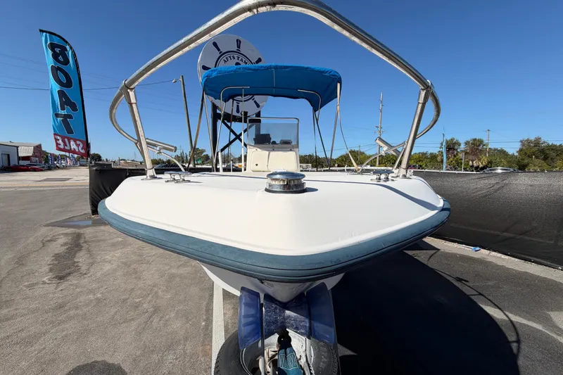 Slide: The Image of 1991 Grady-White Spirit 175 boat for sale, front view with blue canopy. - 12