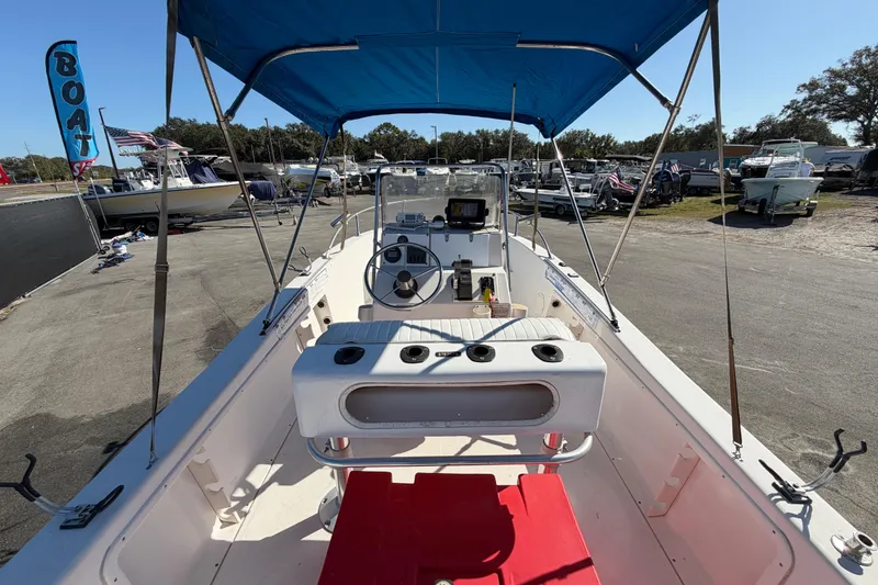 Slide: The Image of 1991 Grady-White Spirit 175 boat with blue canopy, docked outdoors. - 14