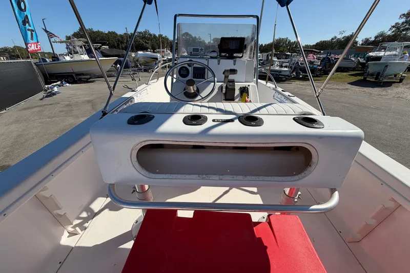 Slide: The Image of 1991 Grady-White Spirit 175 boat interior with steering console and red carpet. - 16