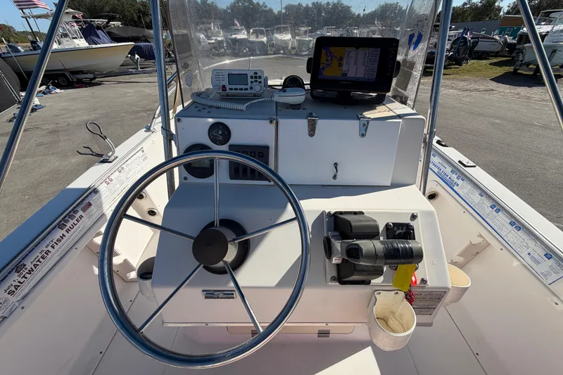 Slide: The Image of 1991 Grady-White Spirit 175 boat dashboard with steering wheel and navigation equipment. - 18