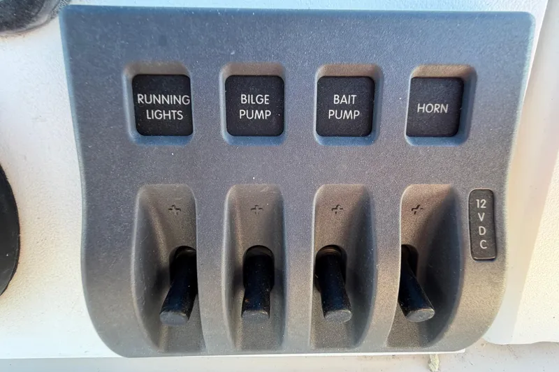 Slide: The Image of Control panel of a 1991 Grady-White Spirit 175 boat with labeled switches. - 20