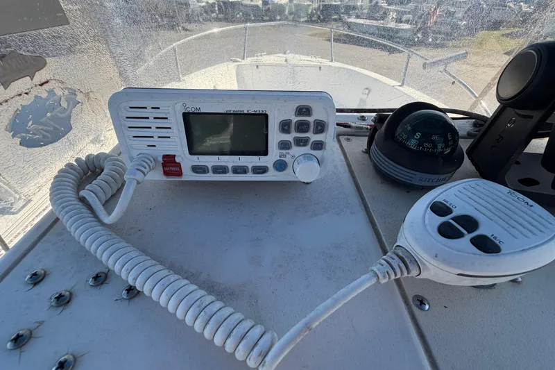 Slide: The Image of 1991 Grady-White Spirit 175 boat dashboard with Icom VHF radio and compass. - 23