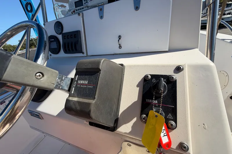 Slide: The Image of 1991 Grady-White Spirit 175 boat dashboard with Yamaha controls and steering wheel. - 27