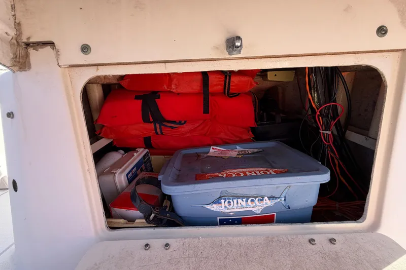 Slide: The Image of Storage compartment of 1991 Grady-White Spirit 175 with life jackets and gear. - 29