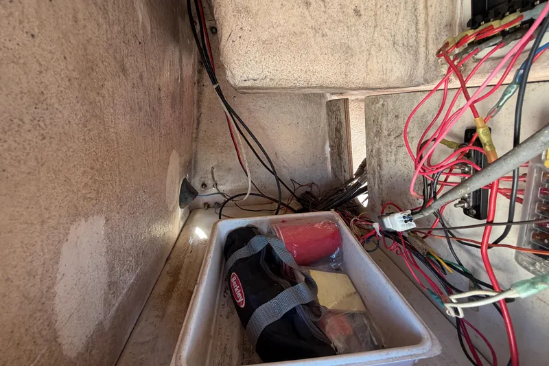 Slide: The Image of Interior view of a 1991 Grady-White Spirit 175 boat showing wiring and storage compartment. - 33