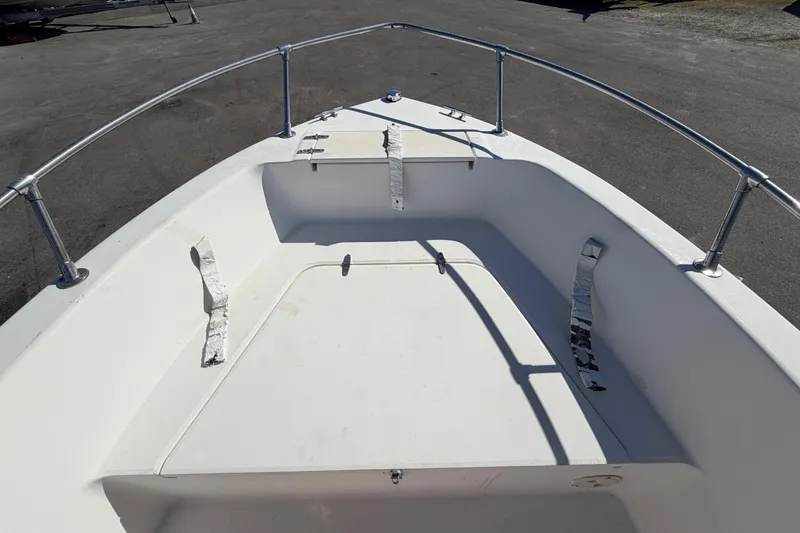 Slide: The Image of 1991 Grady-White Spirit 175 boat interior with white seating and metal railings. - 35