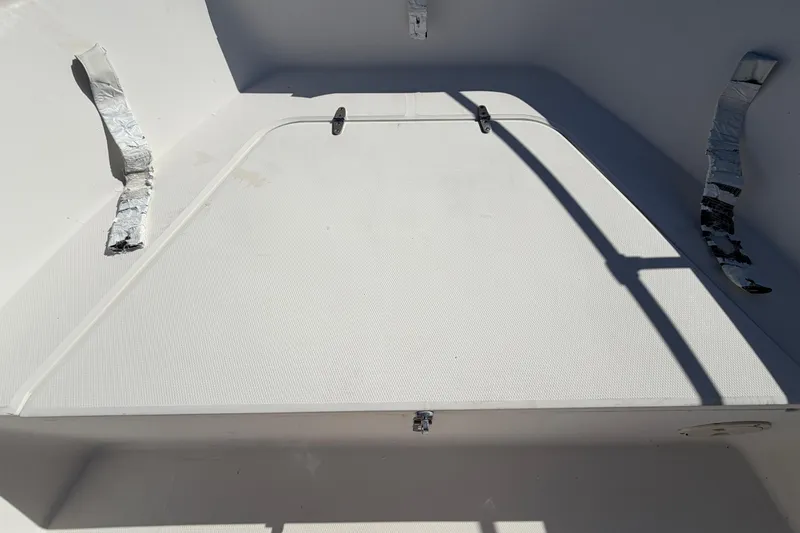 Slide: The Image of 1991 Grady-White Spirit 175 boat interior with storage compartment and metallic straps. - 36