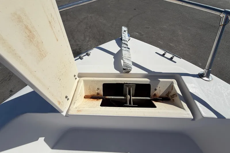 Slide: The Image of Open anchor compartment on 1991 Grady-White Spirit 175 boat, showing rust and wear. - 40