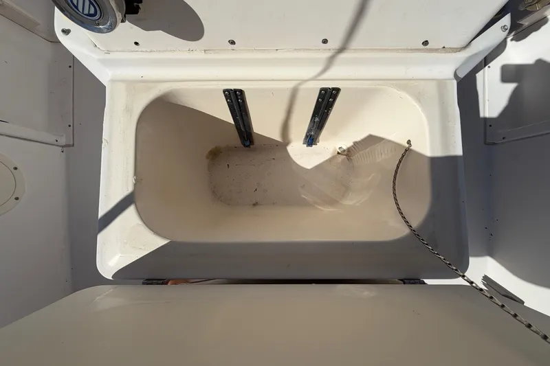 Slide: The Image of 1991 Grady-White Spirit 175 boat interior storage compartment, white and spacious. - 47