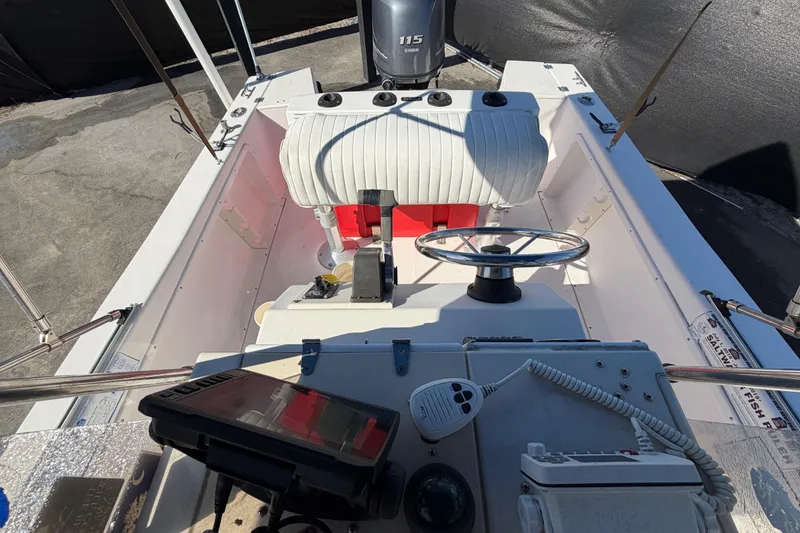 Slide: The Image of 1991 Grady-White Spirit 175 boat interior with steering wheel and Yamaha 115 engine. - 48