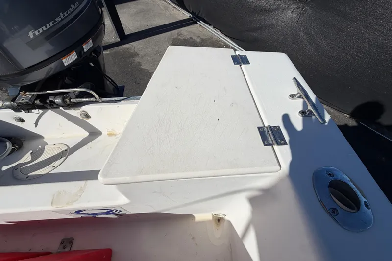 Slide: The Image of 1991 Grady-White Spirit 175 boat deck with four-stroke engine and storage compartment. - 53