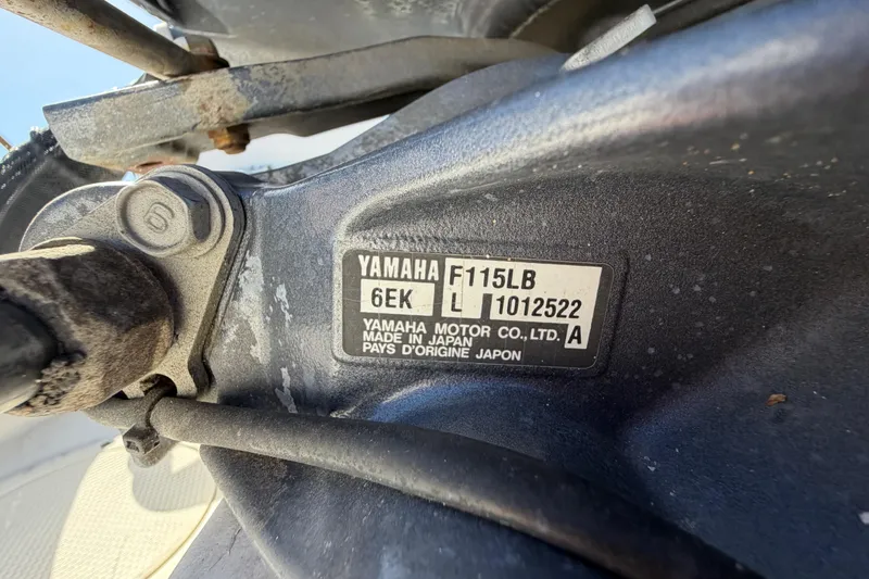 Slide: The Image of Trailer wheel of 1991 Grady-White Spirit 175, secured with a chock on wet pavement. - 56