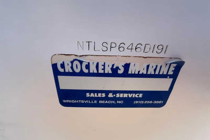 Slide: The Image of Trailer wheel of a 1991 Grady-White Spirit 175 boat on asphalt. - 57