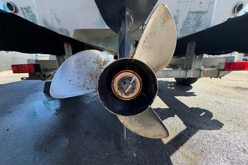 Slide: The Image of 1991 Grady-White Spirit 175 boat propeller and trailer on pavement. - 6