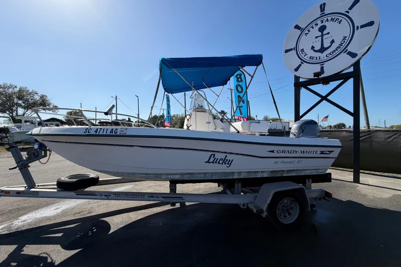 Slide: The Image of 1991 Grady-White Spirit 175 boat on trailer with blue canopy at dealership. - 9