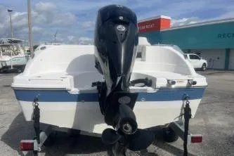 Slide: The Image of 2022 Hurricane SunDeck 192 OB boat with outboard motor, parked outdoors. - 5