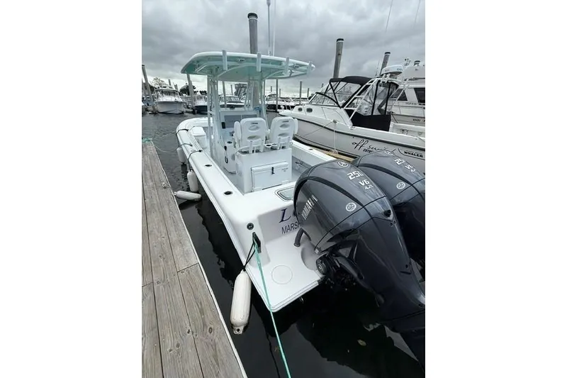Slide: The Image of Contender 28 Tournament 2026 boat docked with twin outboard engines. - 7