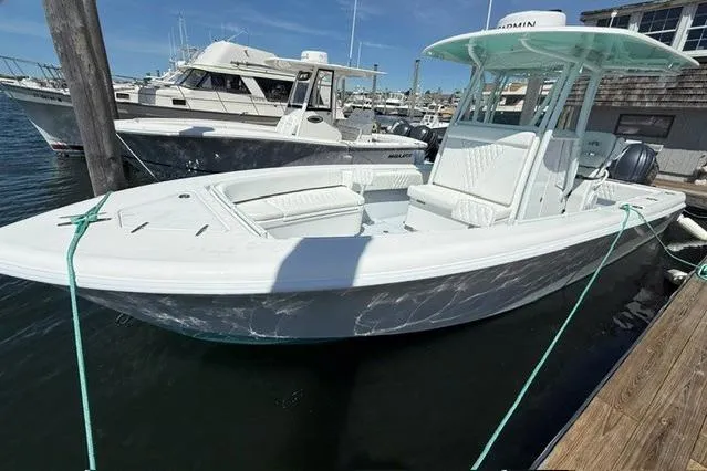 Slide: The Image of 2026 Contender 28 Tournament boat docked at marina, featuring sleek white design and spacious deck. - 8
