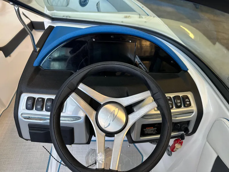 Slide: The Image of 2025 Regal 2000ES Bowrider dashboard with steering wheel and control panel. - 14