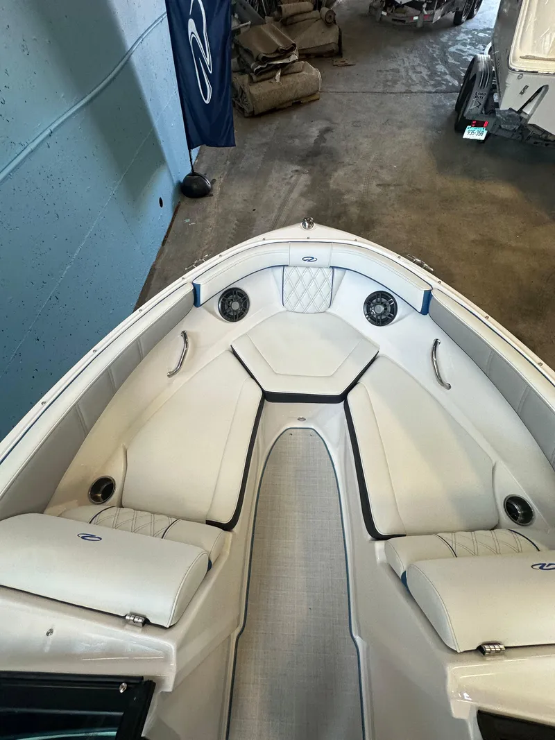 Slide: The Image of 2025 Regal 2000ES Bowrider interior with white seating and speakers. - 17