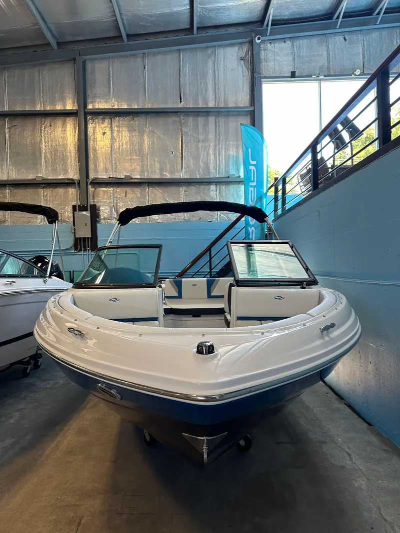 Slide: The Image of 2025 Regal 2000ES Bowrider boat displayed in a showroom. - 3