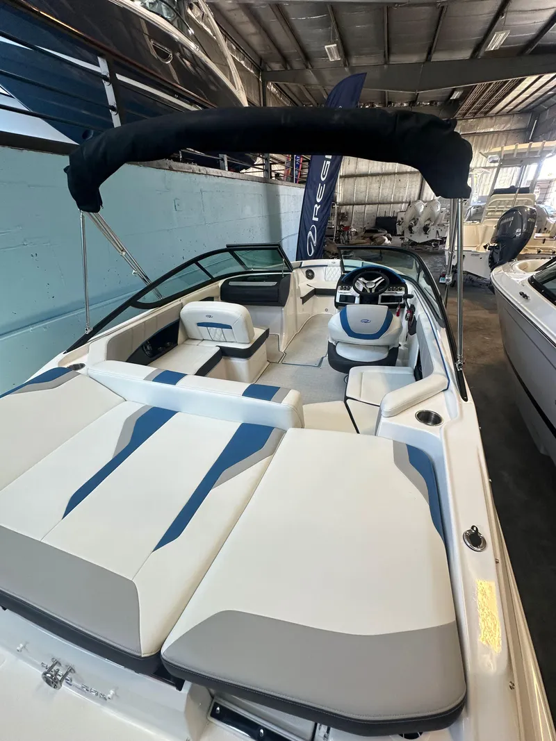 Slide: The Image of 2025 Regal 2000ES Bowrider boat with sleek interior design in a showroom. - 8