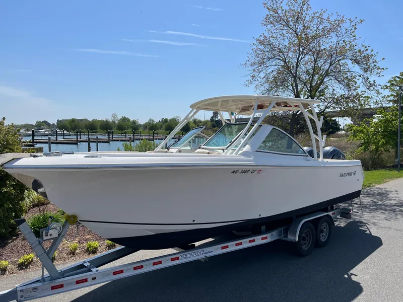 The Image of 2018 Sailfish 275 DC boat on trailer, sunny day. - 0
