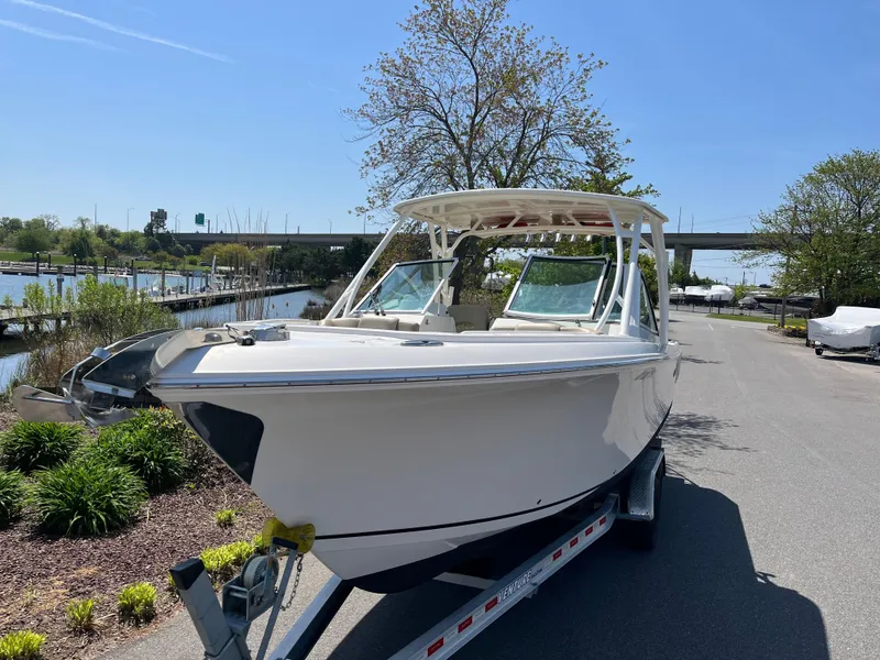 Slide: The Image of 2018 Sailfish 275 DC boat on trailer, sunny day. - 3