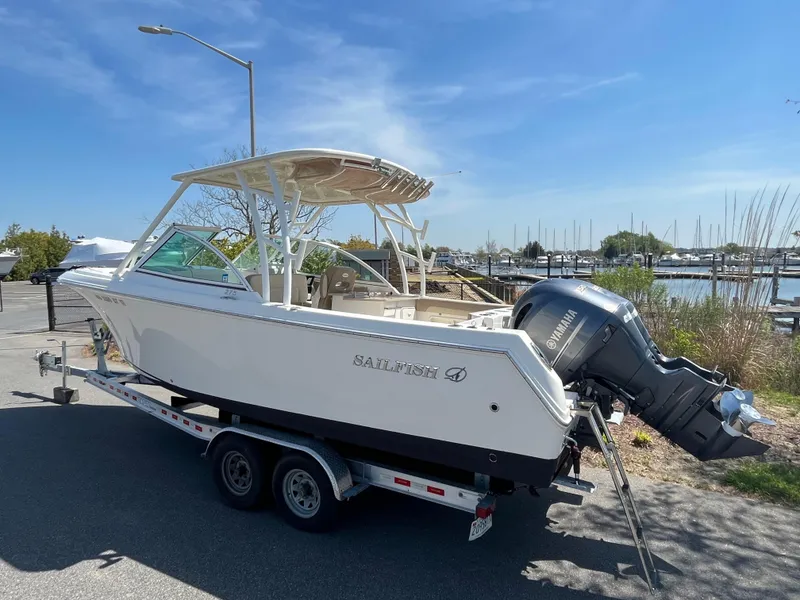 Slide: The Image of 2018 Sailfish 275 DC boat on trailer at marina. - 5