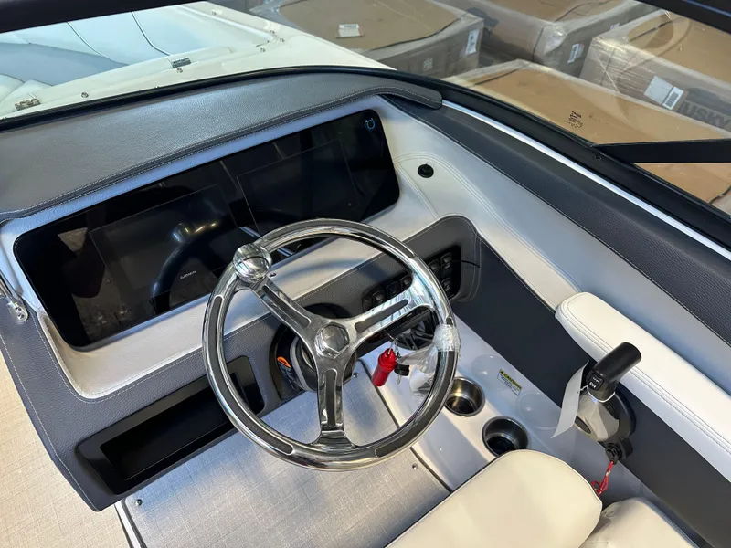 Slide: The Image of 2025 Regal LX2 boat dashboard with sleek steering wheel and modern controls. - 14