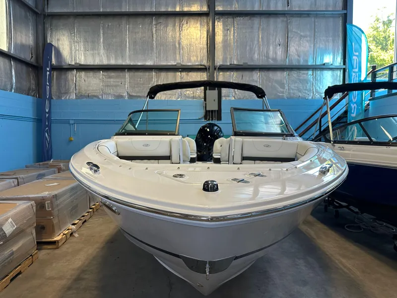 Slide: The Image of 2025 Regal LX2 boat in showroom, sleek white design, modern features. - 4