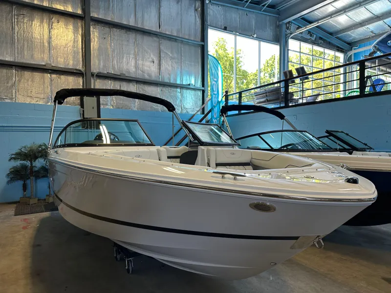 Slide: The Image of 2025 Regal LX2 boat displayed in a showroom, sleek design, white exterior. - 5