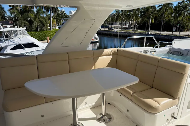 Slide: The Image of Luxurious seating area on 2014 Pacific Mariner 85 Motor Yacht, docked with palm trees. - 10