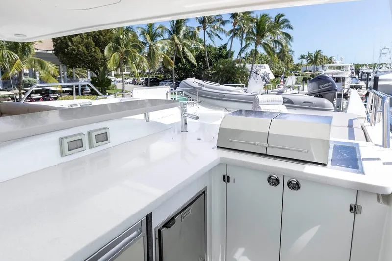 Slide: The Image of Luxurious 2014 Pacific Mariner 85 Motor Yacht with outdoor kitchen and scenic marina view. - 14