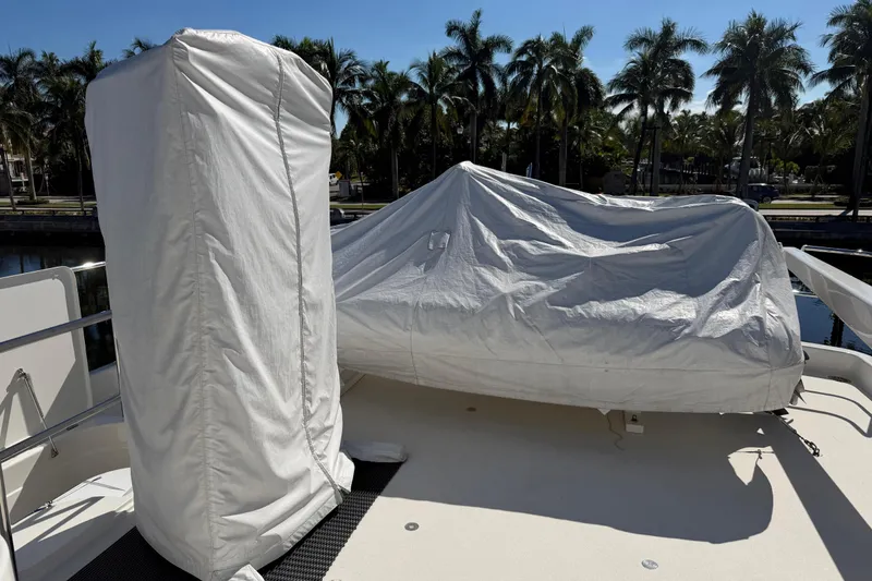 Slide: The Image of Covered equipment on 2014 Pacific Mariner 85 Motor Yacht deck, surrounded by palm trees. - 17
