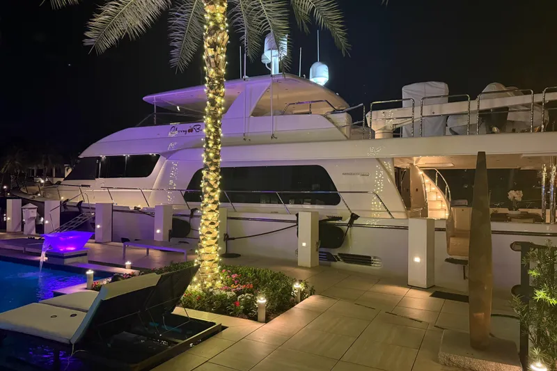Slide: The Image of Luxurious 2014 Pacific Mariner 85 Motor Yacht docked at night, illuminated by elegant lighting. - 18