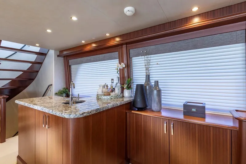 Slide: The Image of Luxurious interior of 2014 Pacific Mariner 85 Motor Yacht with elegant wood finishes and granite countertop. - 25