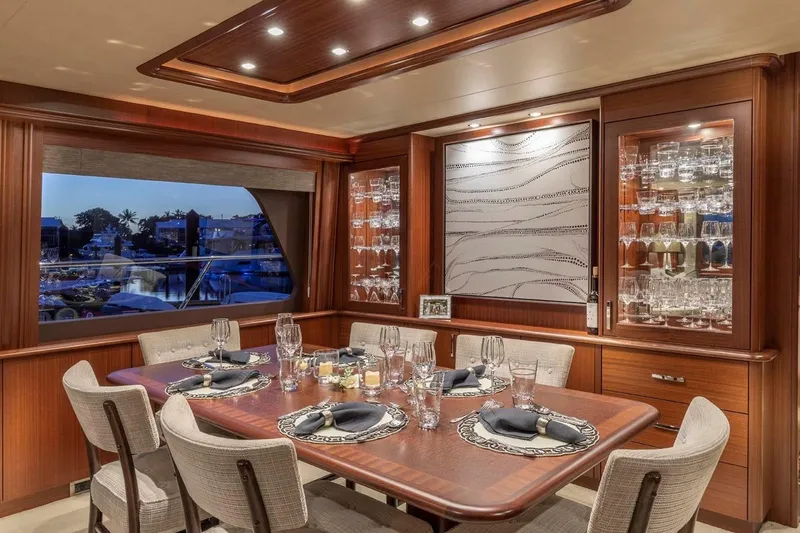 Slide: The Image of Luxurious dining area on 2014 Pacific Mariner 85 Motor Yacht, featuring elegant table setting and glassware. - 28