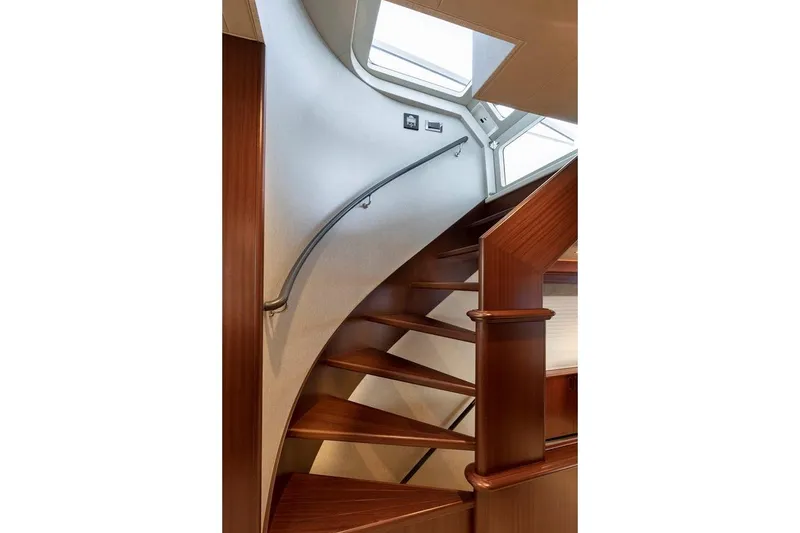 Slide: The Image of Elegant wooden staircase inside 2014 Pacific Mariner 85 Motor Yacht, featuring sleek design and skylight. - 29