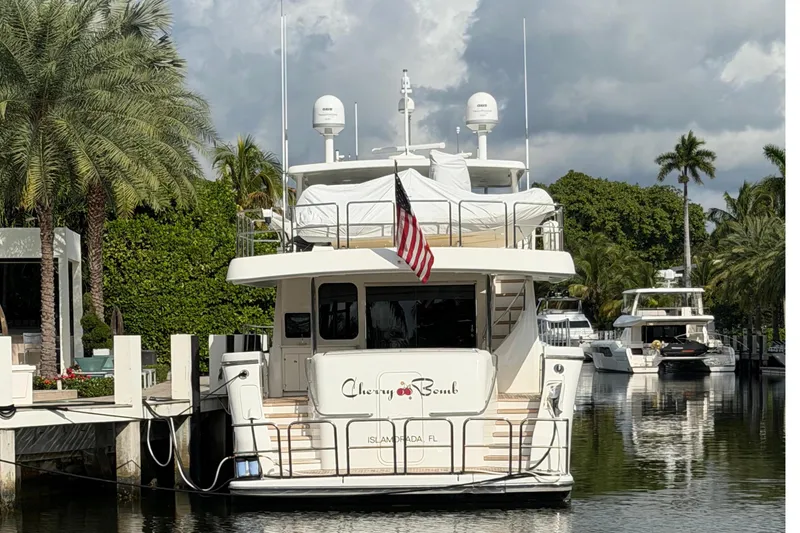 Slide: The Image of 2014 Pacific Mariner 85 Motor Yacht docked, surrounded by palm trees and calm water. - 3
