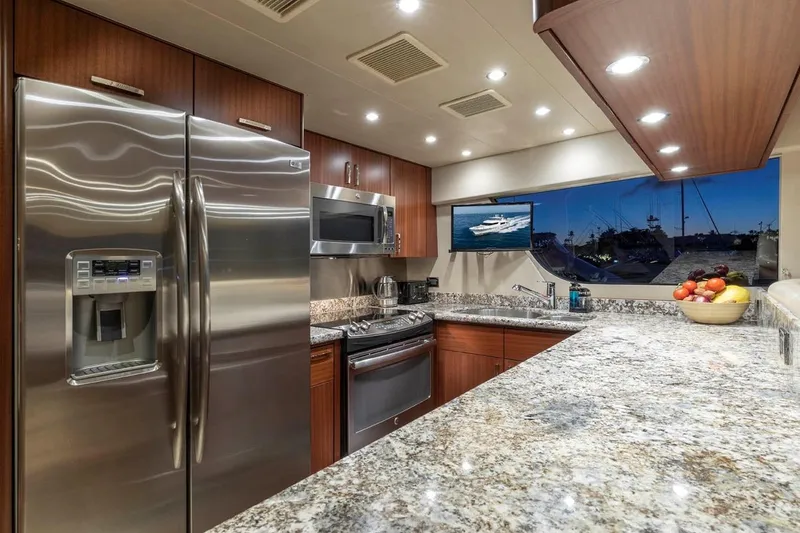 Slide: The Image of Luxurious kitchen in 2014 Pacific Mariner 85 Motor Yacht with modern appliances and granite countertops. - 31