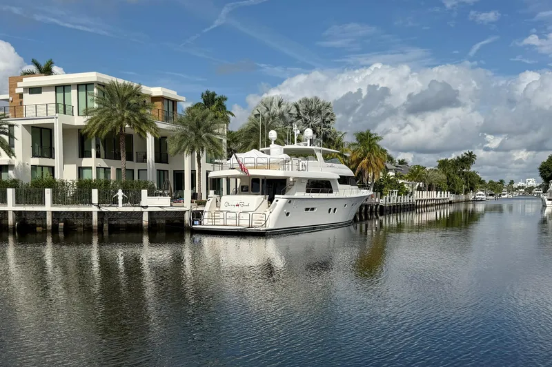 Slide: The Image of 2014 Pacific Mariner 85 Motor Yacht docked by luxury waterfront homes. - 4