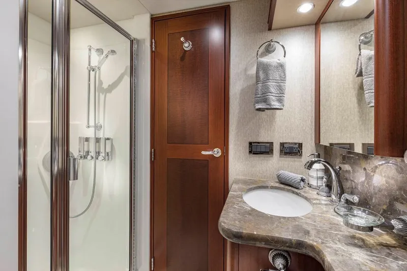 Slide: The Image of Luxurious bathroom in 2014 Pacific Mariner 85 Motor Yacht with marble countertop and glass shower. - 41
