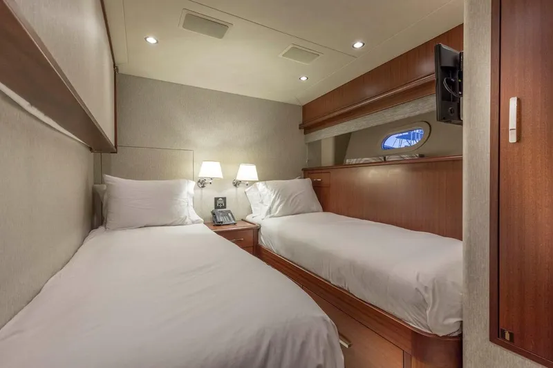 Slide: The Image of Luxurious twin cabin in 2014 Pacific Mariner 85 Motor Yacht, featuring elegant wood finishes. - 42