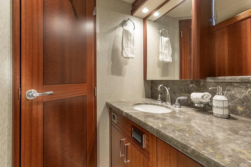 Slide: The Image of Luxurious bathroom in 2014 Pacific Mariner 85 Motor Yacht with marble countertop and wooden accents. - 43