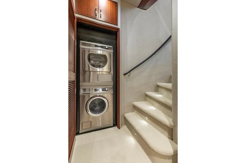 Slide: The Image of Laundry area with stacked washer and dryer on 2014 Pacific Mariner 85 Motor Yacht. - 45