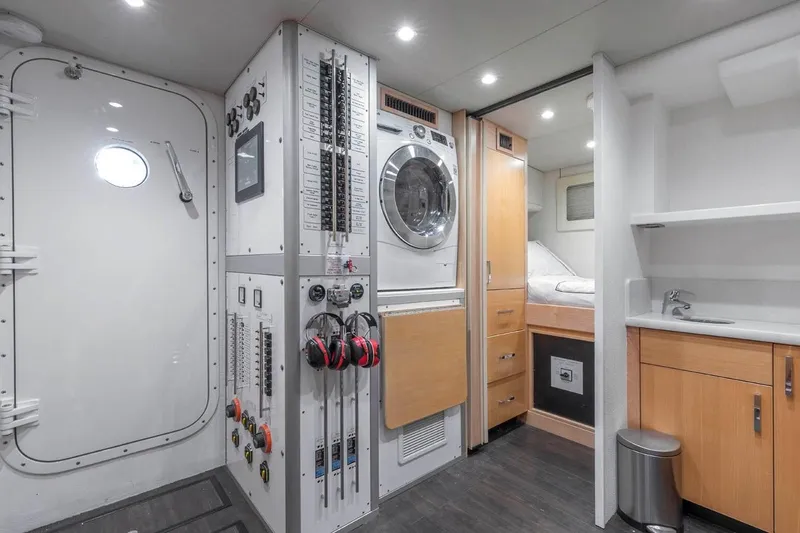 Slide: The Image of Engine room of 2014 Pacific Mariner 85 Motor Yacht with control panels and washer. - 48