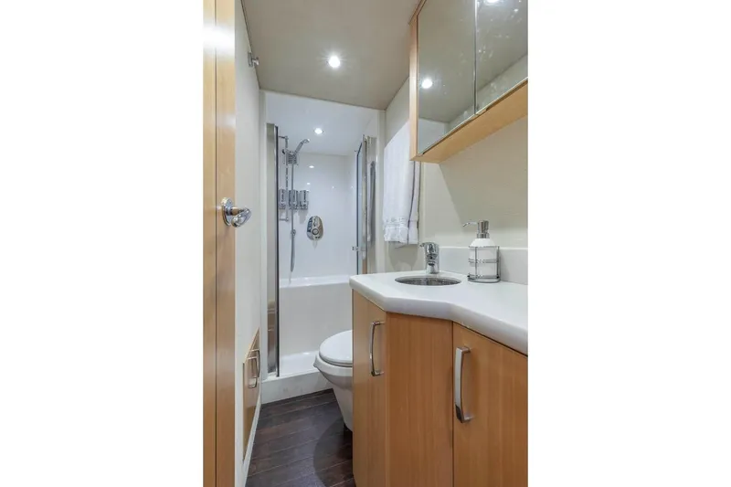 Slide: The Image of Luxurious bathroom in 2014 Pacific Mariner 85 Motor Yacht with modern fixtures and wood accents. - 51